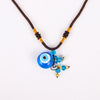 Amrita Court's cool Evil's Eye Charm Diffusing necklace, made of murano glass. It is a diffuser bottle to contain a small amount of essential oils. Diffusing on the go.